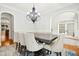 Dining room featuring a large table, upholstered chairs, and elegant chandelier at 10909 Grand Journey Ave, Raleigh, NC 27614