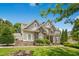 Attractive two-story home with stone accents, lush landscaping, and well-maintained lawn at 10909 Grand Journey Ave, Raleigh, NC 27614