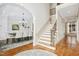 Open foyer leading to the staircase and dining area, showcasing hardwood flooring at 10909 Grand Journey Ave, Raleigh, NC 27614