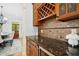 The kitchen features wood cabinets, granite countertops, a wine rack, and stainless steel beverage cooler at 10909 Grand Journey Ave, Raleigh, NC 27614