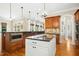 The island in this kitchen has a white cabinet base and black granite countertop and stainless steel appliances at 10909 Grand Journey Ave, Raleigh, NC 27614