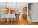 Spacious kitchen showcasing wood cabinetry, an island with bar seating, and stainless steel appliances at 10909 Grand Journey Ave, Raleigh, NC 27614