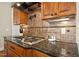 The kitchen features granite countertops, a tile backsplash, and a stainless steel gas range at 10909 Grand Journey Ave, Raleigh, NC 27614