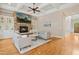 This open concept living room has hardwood floors, built-in cabinets and a stone fireplace at 10909 Grand Journey Ave, Raleigh, NC 27614
