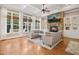 The living room has coffered ceilings, a ceiling fan, hardwood floors and a stone fireplace with built-ins at 10909 Grand Journey Ave, Raleigh, NC 27614