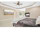 Main bedroom with a large TV, a decorative fireplace, and stylish decor at 10909 Grand Journey Ave, Raleigh, NC 27614