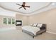 Spacious main bedroom featuring a fireplace and a seating area by the window at 10909 Grand Journey Ave, Raleigh, NC 27614