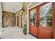 Covered porch featuring stone accents, double front doors, and elegant lighting at 10909 Grand Journey Ave, Raleigh, NC 27614