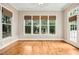 The sunroom features hardwood floors, neutral walls, and a bank of windows overlooking the backyard at 10909 Grand Journey Ave, Raleigh, NC 27614
