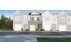 New townhome with stone facade and individual garages on a well manicured street at 1107 Weavers Trace Dr, Zebulon, NC 27597