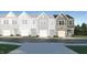 New townhome exterior showcases stone accents, siding, and attached one car garage at 1133 Weavers Trace Dr, Zebulon, NC 27597