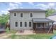 Back exterior of home shows screened porch, picnic table, and playground at 1138 Bexley Hills Bnd, Apex, NC 27502