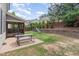 Spacious backyard with a picnic table, playground, lush green grass, and landscaping at 1138 Bexley Hills Bnd, Apex, NC 27502