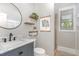 Modern bathroom with stylish vanity, round mirror, and walk-in shower at 1138 Bexley Hills Bnd, Apex, NC 27502