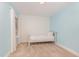 Bright bedroom features a twin bed, beige carpet, blue walls, and geometric patterned accent wall at 1138 Bexley Hills Bnd, Apex, NC 27502