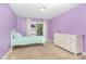 Cozy bedroom with a bed, dresser, plush carpet, and curtains filtering sunlight at 1138 Bexley Hills Bnd, Apex, NC 27502