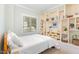 Cozy bedroom featuring custom built-in shelves and a large window at 1138 Bexley Hills Bnd, Apex, NC 27502