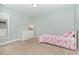 Bright bedroom with neutral carpet, a dresser, and a bed with butterfly patterned bedding at 1138 Bexley Hills Bnd, Apex, NC 27502