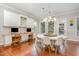Bright dining area with built-in desks, modern lighting, and backyard views at 1138 Bexley Hills Bnd, Apex, NC 27502