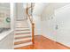 Inviting entryway with hardwood floors, stairs, and coat rack at 1138 Bexley Hills Bnd, Apex, NC 27502