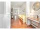 Elegant foyer with hardwood floors, white columns, and a charming, decorative bench at 1138 Bexley Hills Bnd, Apex, NC 27502