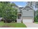 Charming two-story home with a welcoming front porch, manicured lawn and attached two car garage at 1138 Bexley Hills Bnd, Apex, NC 27502