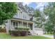 Charming two-story home with a welcoming front porch, manicured lawn and attached two car garage at 1138 Bexley Hills Bnd, Apex, NC 27502