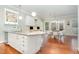 Open kitchen with an island, granite countertops, and seating for entertaining at 1138 Bexley Hills Bnd, Apex, NC 27502
