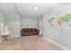 Spacious living room with comfortable seating, a study area, and a world map wall decal at 1138 Bexley Hills Bnd, Apex, NC 27502