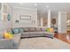Comfortable living room showcasing a large sectional sofa, hardwood floors, and an open layout at 1138 Bexley Hills Bnd, Apex, NC 27502