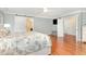 Bright main bedroom with hardwood floors, ceiling fan, and ensuite bathroom access at 1138 Bexley Hills Bnd, Apex, NC 27502