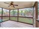 Screened in porch with wood ceiling, ceiling fan, and outdoor view of a playground at 1138 Bexley Hills Bnd, Apex, NC 27502