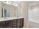 Bathroom featuring double vanity, a large mirror and a bright white bathtub/shower combo at 1213 Silver Beach Way, Raleigh, NC 27606