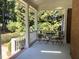 Cozy back porch featuring black wrought iron patio set, perfect for relaxation at 122 Barringer Dr, Garner, NC 27529