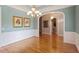 Dining room featuring hardwood floors, wainscoting, and ornate chandelier at 122 Barringer Dr, Garner, NC 27529