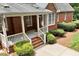 Brick home with a covered porch, manicured shrubs, and a concrete patio perfect for entertaining at 122 Barringer Dr, Garner, NC 27529