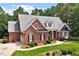 Well-maintained brick home with professional landscaping, concrete drive, and charming curb appeal at 122 Barringer Dr, Garner, NC 27529