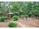 Wooden gazebo surrounded by lush trees and landscaping provides a relaxing retreat at 122 Barringer Dr, Garner, NC 27529