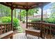 View from inside the gazebo shows lush trees and landscaping, the backyard and lovely home at 122 Barringer Dr, Garner, NC 27529