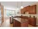 Kitchen features a central island with seating, stainless steel appliances, granite countertops, and wood cabinets at 122 Barringer Dr, Garner, NC 27529