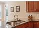 Gourmet kitchen features a stainless steel sink, granite countertops, and a stylish tile backsplash at 122 Barringer Dr, Garner, NC 27529