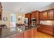 Open kitchen featuring stainless steel appliances, custom cabinetry, granite countertops, and eat-in island at 122 Barringer Dr, Garner, NC 27529