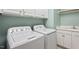 Bright laundry room featuring modern washer and dryer, ample storage cabinets, and a utility sink at 122 Barringer Dr, Garner, NC 27529