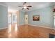 Open living room featuring hardwood floors, an archway, and a fireplace at 122 Barringer Dr, Garner, NC 27529