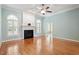 Bright living room with fireplace, large windows, and hardwood floors at 122 Barringer Dr, Garner, NC 27529