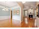 Spacious living room with hardwood floors, fireplace, and elegant chandelier at 122 Barringer Dr, Garner, NC 27529