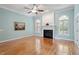 Comfortable living room features a fireplace, hardwood floors, and large windows at 122 Barringer Dr, Garner, NC 27529