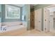 Elegant primary bathroom with soaking tub, separate shower, and stylish tilework at 122 Barringer Dr, Garner, NC 27529