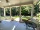 Inviting porch with ceiling fan looks out onto the well-maintained yard with lovely landscaping and mature trees at 122 Barringer Dr, Garner, NC 27529