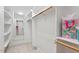 Bright, spacious walk-in closet with ample shelving and a mirror for getting ready at 122 Barringer Dr, Garner, NC 27529